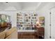 Bright living room featuring hardwood floors and a beautiful built-in bookcase, offering a cozy atmosphere at 2107 Delaney Ave, Orlando, FL 32806