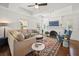 Spacious living room showcasing a beamed ceiling, hardwood floors, and an inviting fireplace at 2107 Delaney Ave, Orlando, FL 32806