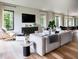 Sun-filled living room featuring hardwood floors, modern furniture, and large windows with backyard views at 22 W Hazel St, Orlando, FL 32804
