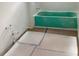 Bathroom undergoing renovation with a partially installed green tub at 2342 Broadbrook Drive, St Cloud, FL 34771