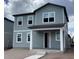 Two-story gray home with multiple windows and covered front porch at 2342 Broadbrook Drive, St Cloud, FL 34771
