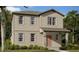 Two-story tan home with multiple windows and covered front porch at 2342 Broadbrook Drive, St Cloud, FL 34771
