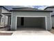 Spacious two car garage with concrete floor and light-grey wood siding at 2342 Broadbrook Drive, St Cloud, FL 34771