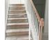 Wooden stairs leading to the next floor, complemented by a wooden handrail and white spindles at 2342 Broadbrook Drive, St Cloud, FL 34771