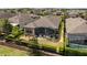 Aerial view of the property, showcasing the screened lanai, fenced backyard and landscaping at 2530 Stargrass Cir, Clermont, FL 34715