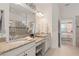 Luxurious bathroom featuring granite countertops, dual vanities, and a spacious walk-in shower for a spa-like experience at 2530 Stargrass Cir, Clermont, FL 34715
