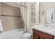 Bathroom with a tiled shower, framed mirror, decorative art, and modern vanity at 2530 Stargrass Cir, Clermont, FL 34715