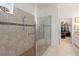 Modern bathroom with a glass-enclosed shower and a view into the spacious walk-in closet at 2530 Stargrass Cir, Clermont, FL 34715