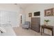 Comfortable bedroom with a dresser, sitting chair, and access to an ensuite bathroom at 2530 Stargrass Cir, Clermont, FL 34715