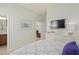 Well-lit bedroom with a large TV, dresser, and view into the large walk-in closet at 2530 Stargrass Cir, Clermont, FL 34715