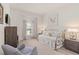 Cozy bedroom with a comfortable seating area and a view of the outdoor scenery at 2530 Stargrass Cir, Clermont, FL 34715
