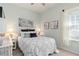 Comfortable bedroom featuring cool paint, stylish decor, and lots of natural light at 2530 Stargrass Cir, Clermont, FL 34715