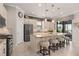 Bright kitchen with stainless steel appliances, granite counters, island with seating, and access to the outdoor living area at 2530 Stargrass Cir, Clermont, FL 34715