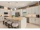 Well-equipped kitchen featuring granite countertops, stainless steel appliances, and a large island with bar seating at 2530 Stargrass Cir, Clermont, FL 34715