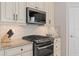 Modern kitchen featuring stainless steel appliances, stone backsplash and granite countertops, offering both style and functionality at 2530 Stargrass Cir, Clermont, FL 34715