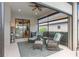Inviting screened-in lanai boasting comfortable seating and a view of the lush backyard at 2530 Stargrass Cir, Clermont, FL 34715