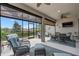 Covered lanai featuring wicker furniture, ceiling fan and a flatscreen TV for relaxation and entertainment at 2530 Stargrass Cir, Clermont, FL 34715