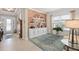 Stylish living room with a decorative wood accent wall, white shelving, and a large window at 2530 Stargrass Cir, Clermont, FL 34715