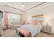 Serene main bedroom boasts a tray ceiling, soft color palette, and a cozy seating area for ultimate relaxation at 2530 Stargrass Cir, Clermont, FL 34715