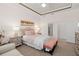 Comfortable main bedroom with elegant furnishings, soft hues, and access to the ensuite bathroom at 2530 Stargrass Cir, Clermont, FL 34715