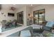 Covered patio with ample seating, ceiling fan, and seamless transition between indoor and outdoor spaces at 2530 Stargrass Cir, Clermont, FL 34715