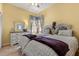 Bright bedroom featuring two beds, yellow walls, and a dresser at 2626 Clarinet Dr, Orlando, FL 32837