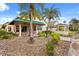 Home's exterior featuring a gazebo, palm trees, and beautiful landscaping at 2626 Clarinet Dr, Orlando, FL 32837