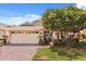Charming home featuring a brick driveway, attached garage, and mature landscaping at 2626 Clarinet Dr, Orlando, FL 32837