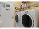 Laundry room with washer, dryer, shelving, and white door at 2626 Clarinet Dr, Orlando, FL 32837