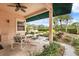 Covered patio with outdoor seating overlooking a garden with a gazebo and pond at 2626 Clarinet Dr, Orlando, FL 32837