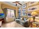 Cozy sitting room bathed in natural light with a comfortable couch and artwork at 2626 Clarinet Dr, Orlando, FL 32837