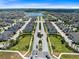 Aerial view of a new neighborhood with a manicured entrance, showcasing lush landscaping at 2638 Giardino Loop, Kissimmee, FL 34741