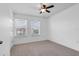 Bright bedroom featuring neutral carpet, a ceiling fan, and natural light from the double window at 2638 Giardino Loop, Kissimmee, FL 34741