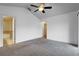 Bedroom with neutral carpet, ceiling fan, ensuite bathroom, and an adjacent doorway leading to another room at 2638 Giardino Loop, Kissimmee, FL 34741