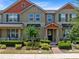 Charming townhouse featuring a well-manicured lawn and colorful exterior accents at 2638 Giardino Loop, Kissimmee, FL 34741