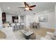 Sunlit living room with dining area, featuring modern decor and a ceiling fan at 2638 Giardino Loop, Kissimmee, FL 34741