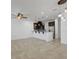 Open-concept living area with tile flooring features modern lighting fixtures and an island bar leading to the kitchen at 2638 Giardino Loop, Kissimmee, FL 34741