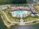 Aerial view of the community pool with lush landscaping and seating around the splash pad at 2638 Giardino Loop, Kissimmee, FL 34741