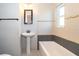Bathroom with a pedestal sink, tiled walls, and modern fixtures at 3024 Sutton Dr, Orlando, FL 32810