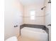 Modern bathroom featuring a bathtub with tiled walls and black fixtures at 3024 Sutton Dr, Orlando, FL 32810