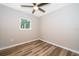 Bedroom with a ceiling fan and wood laminate flooring at 3024 Sutton Dr, Orlando, FL 32810