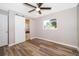 Bright bedroom with wood floors and a sliding door to bathroom at 3024 Sutton Dr, Orlando, FL 32810