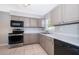 Well-lit kitchen with stainless steel appliances and gray cabinets at 3024 Sutton Dr, Orlando, FL 32810