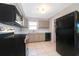 Bright kitchen featuring black appliances and tiled floors at 3024 Sutton Dr, Orlando, FL 32810