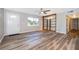 Bright living room showcasing wood floors and a decorative shelving unit at 3024 Sutton Dr, Orlando, FL 32810