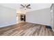 Open concept living room with wood floors and access to kitchen at 3024 Sutton Dr, Orlando, FL 32810