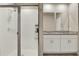 Bathroom featuring a glass-enclosed shower, white tile, and double vanity with white cabinets at 30276 Armenia Rd, Leesburg, FL 34748