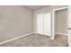 Well lit bedroom featuring a closet with sliding doors, carpet and neutral paint at 30276 Armenia Rd, Leesburg, FL 34748