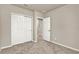 Another well lit bedroom featuring a closet with sliding doors, carpet and neutral paint at 30276 Armenia Rd, Leesburg, FL 34748