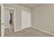 A cozy bedroom with a closet and neutral-colored walls, complemented by plush carpeting at 30276 Armenia Rd, Leesburg, FL 34748